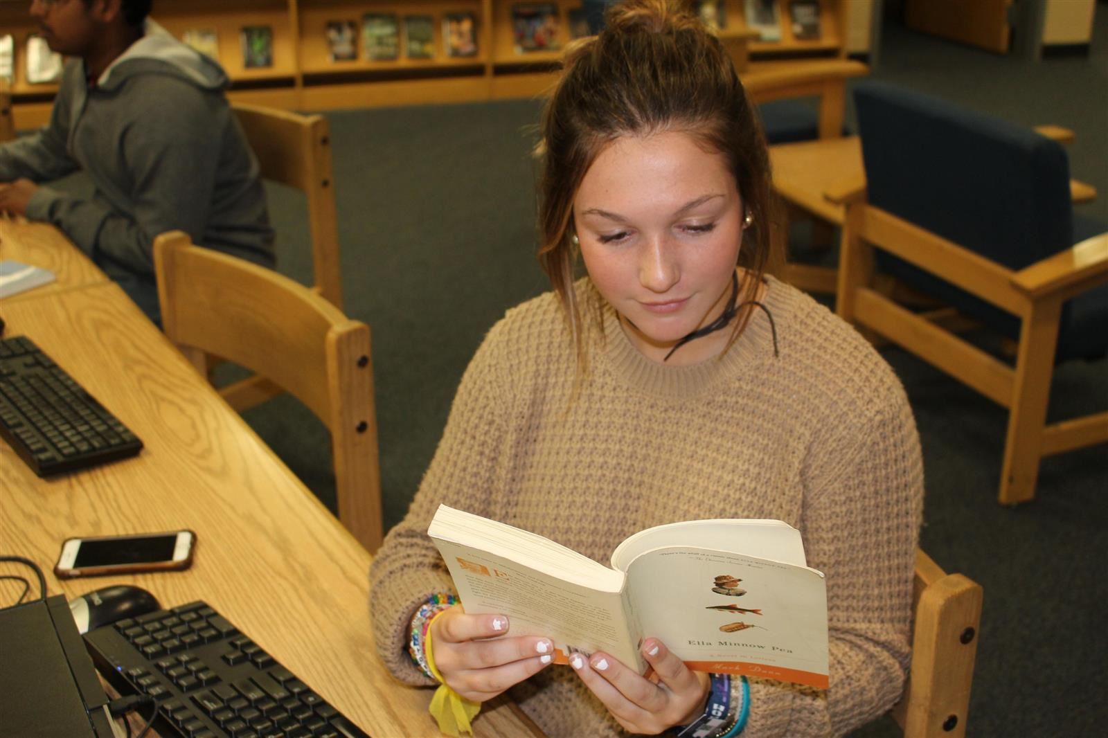 A female student reading for pleasure